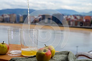 Pouring of natural Asturian cider made fromÃÂ fermented apples in wooden should be poured from great height for air bubbles photo